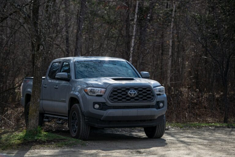 gray chevrolet crew cab pickup truck parked on forest during daytime