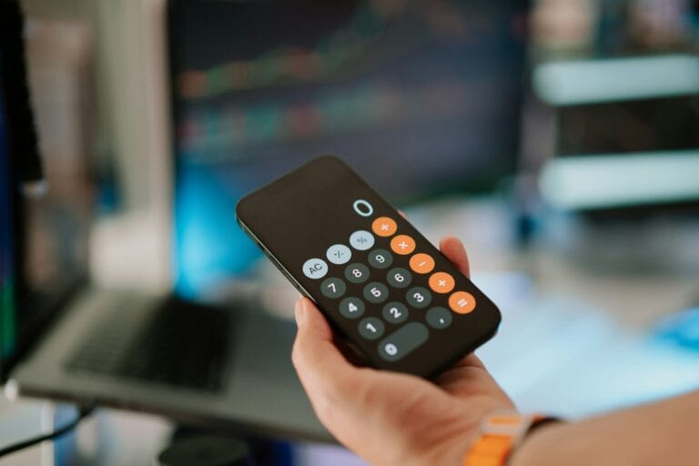 A person holding a remote control in their hand